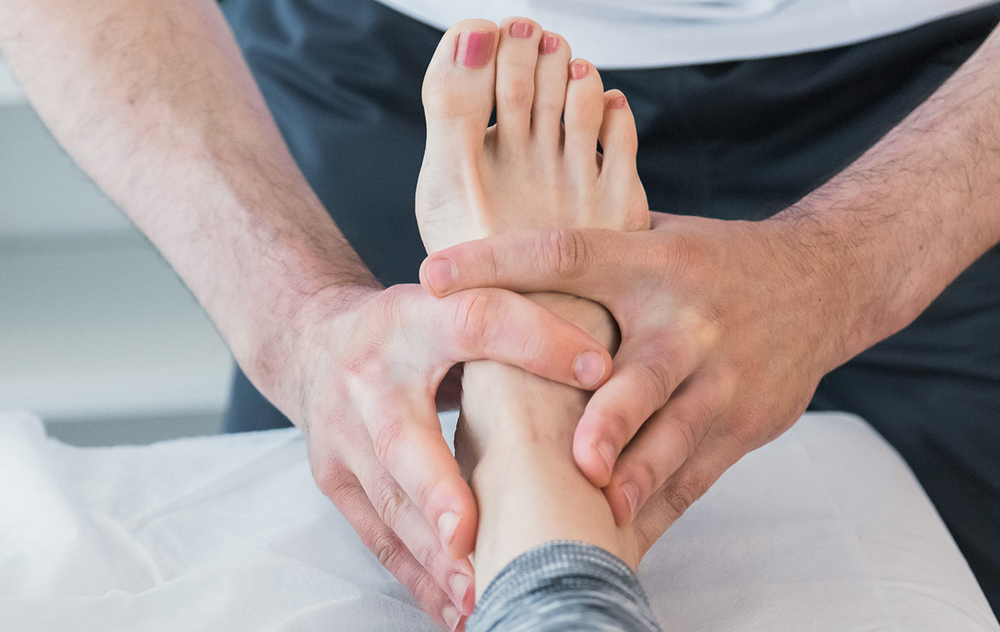 Image of physio helping with ankle pain