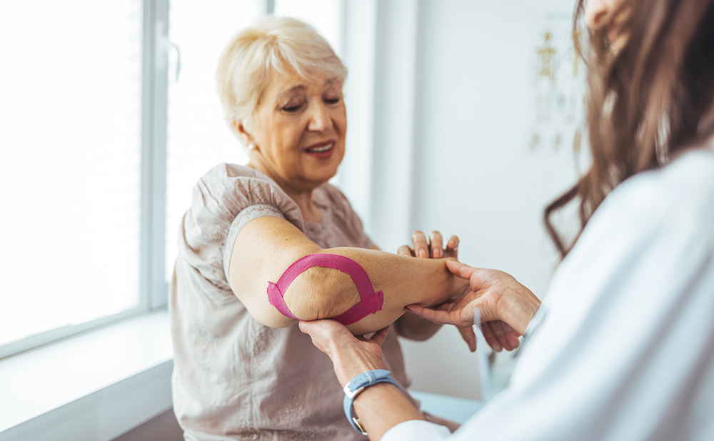 Image of physio talking to client regarding treatment