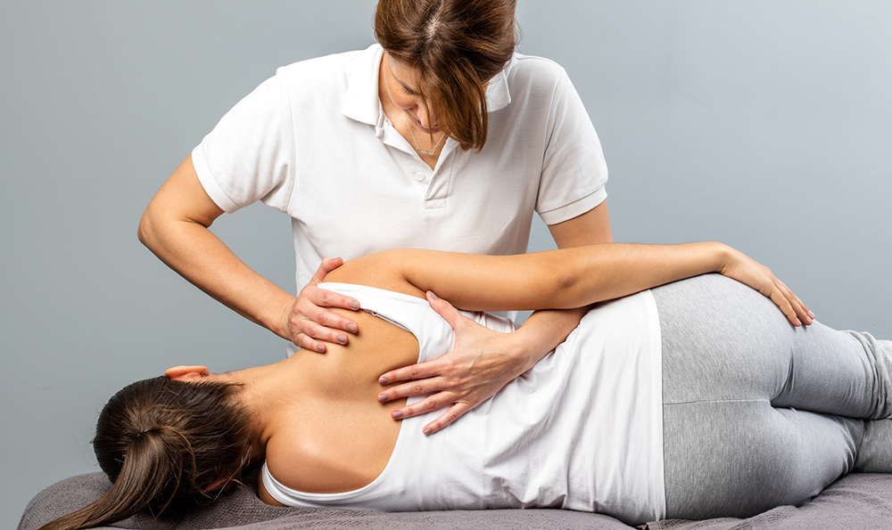 Physio treating a patient's shoulder